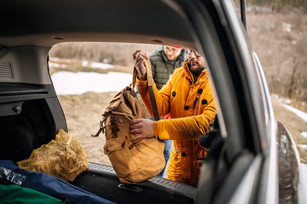 istock Friends on hiking taking backpacks from the car trunk 1310963511