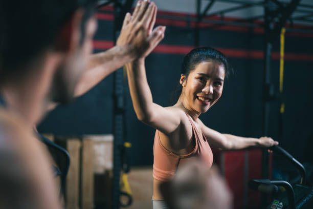 istock Sportsperson giving high five together after success exercised exercising bicycle 1310963844