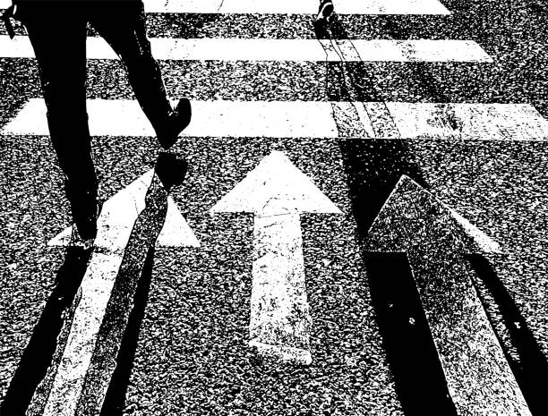 istock Texture asphalt road with feet of man walking on pedestrian zebra 1310963911
