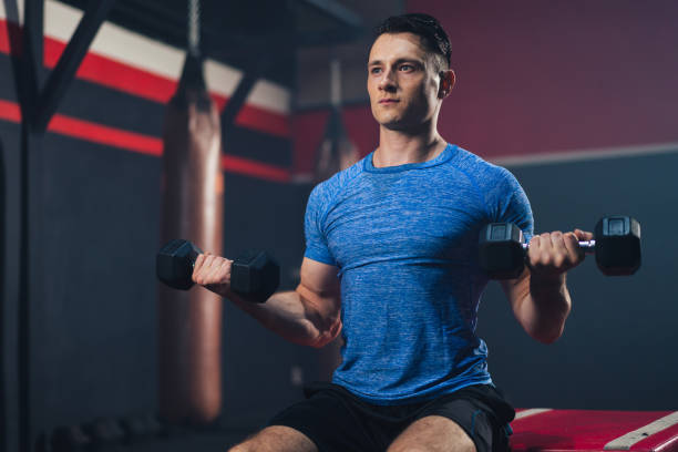 istock Caucasian man lifting dumbbell training for maintain muscle in gym 1310964925