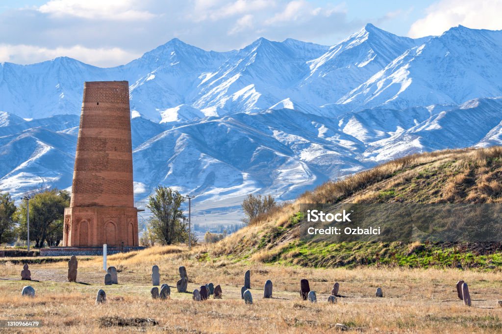 Ancient site of Burana near Bishkek, Kyrgyzstan. Ancient site of Burana with old minaret and tombstones known as Balbas in Kyrgyzstan. Kyrgyzstan Stock Photo