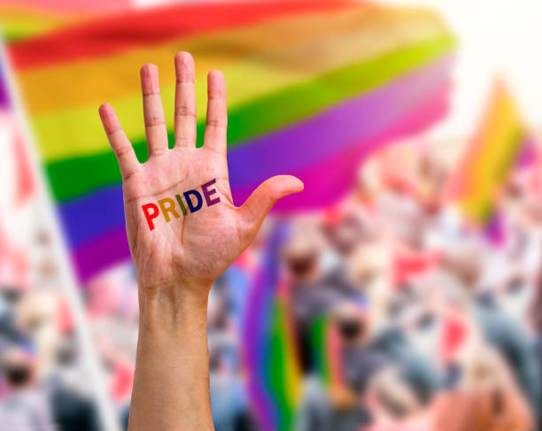 guy's hand with a tattoo at the gay pride event Gay guy's hand with a tattoo that says pride. Symbol of sexual liberation and tolerance arm tattoo ideas for men pictures stock pictures, royalty-free photos & images
