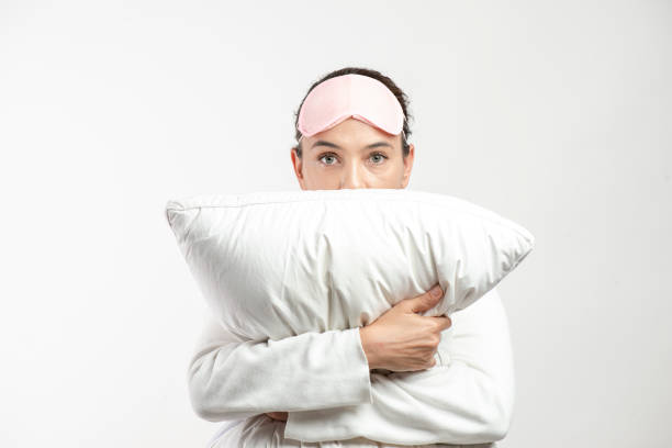 istock Woman Embracing Pillow 1310968031