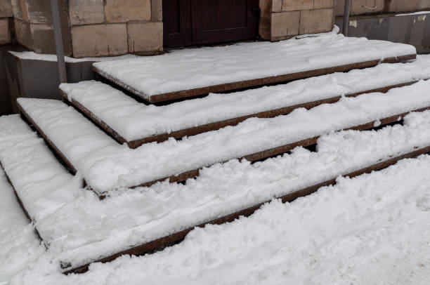 istock steps covered with ice and snow. Dangerous staircase 1310969334