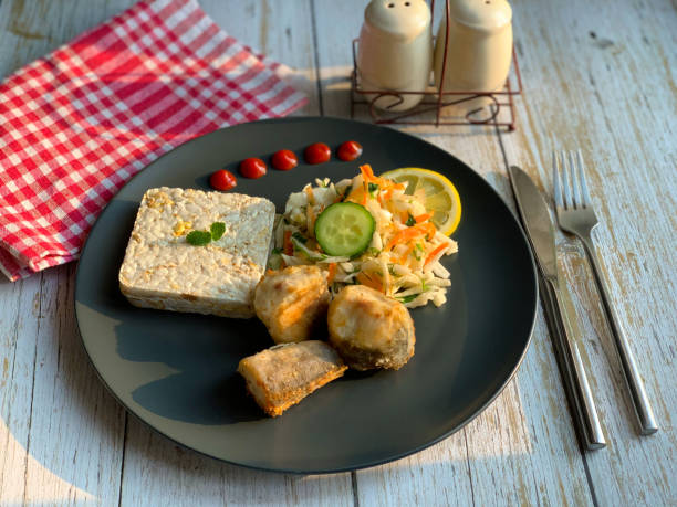 istock Vegetable cabbage salad and fried fish on a plate. 1310971572