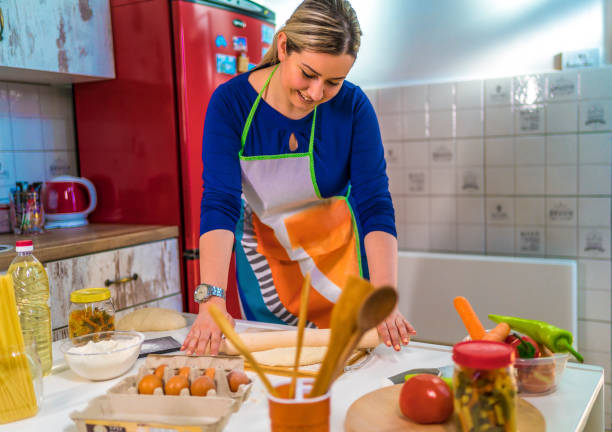 istock Woman kneading dough with rolling pin 1310973559