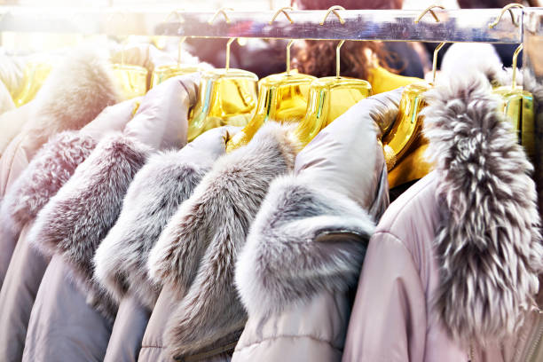istock Winter jackets with grey fur collars in clothing store 1310973754