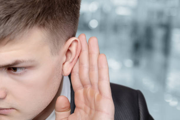 istock Young businessman listens on blurred background. 1310976242