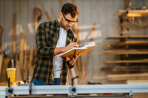 Carpenter Writing Young Carpenter Writing Notes In The Workshop Stock Photo - Download ...