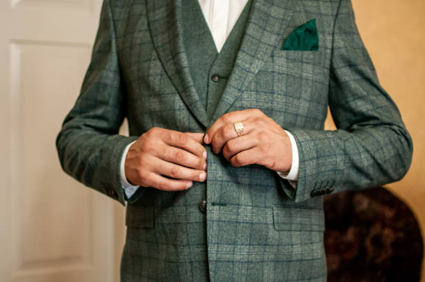 istock groom buckles the button on his jacket 1310977109