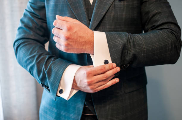 istock A groom fastening a cuff-link on the shirt 1310977182