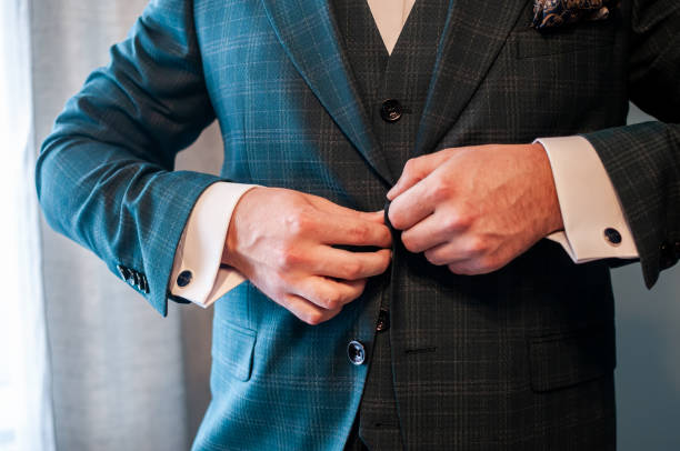 istock groom buckles the button on his jacket 1310977205
