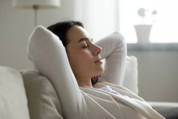 istock Close up peaceful young woman relaxing on cozy sofa 1310977311