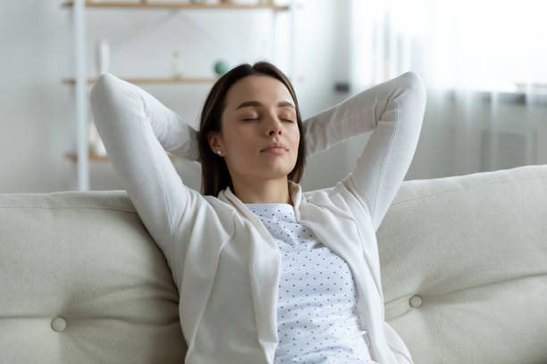 istock Close up peaceful young woman with hands behind head relaxing 1310977312