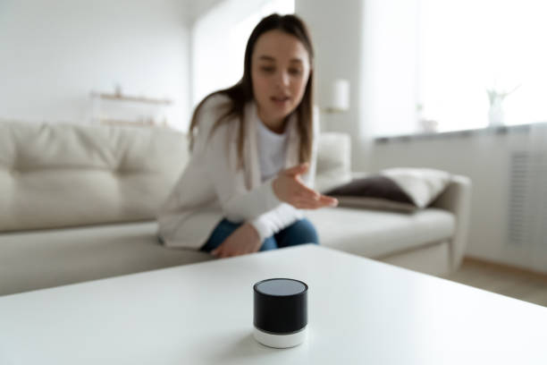 istock Close up young woman talking to wireless smart speaker 1310977318