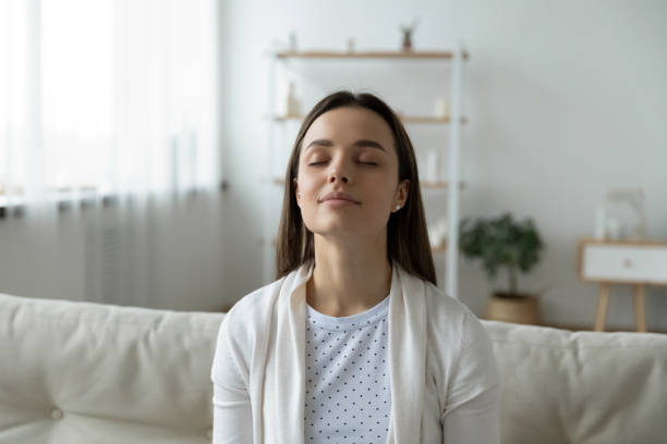 istock Close up calm young woman relaxing with closed eyes 1310977352