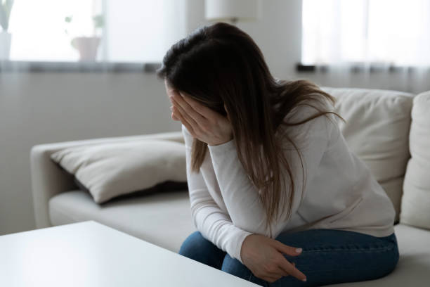 istock Unhappy frustrated young woman worried about problems, sitting alone 1310977357
