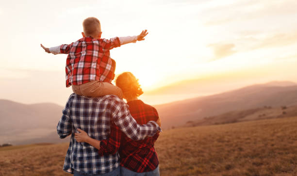 istock Happy family: mother, father and child  son  on nature on sunset 1310978093