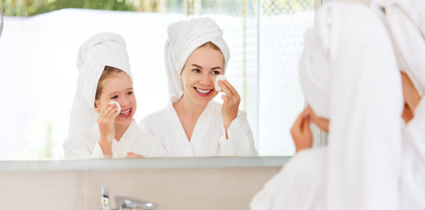 istock Mother and daughter doing face skin care 1310978649
