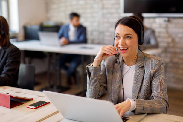 istock Beautiful female customer service talking on the headset with client and smiling 1310978916