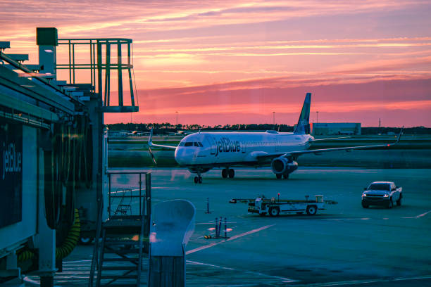 Orlando, Florida, USA - February 09, 2019: A JetBlue Airbus Airplane Is Seen Entering The Apron To Reach Its Destination Airbridge Gate; It Has Just Arrived At Orlando International Airport At Almost Sunset Time. Orlando, Florida, USA - February 09, 2019: A JetBlue Airbus Airplane is seen entering the apron to reach its destination jet bridge gate; it has just landed at Orlando International Airport. The sun has just set. its almost time stock pictures, royalty-free photos & images
