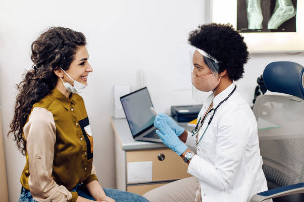 istock African American doctor explaining to her patient how she will test her on Covid-19 1310981486