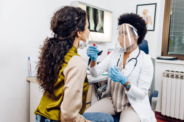 istock African American doctor taking samples from a young woman for testing on Covid 1310981489