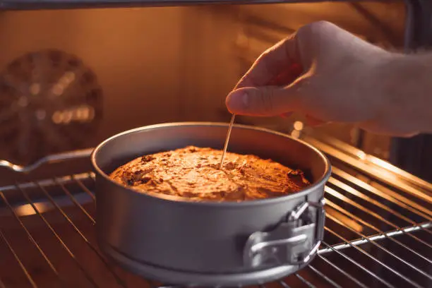 Check a cake for doneness by using the toothpick test.