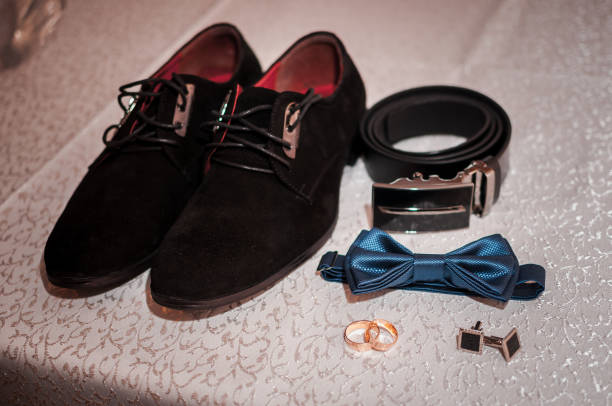 istock Grooms accessories and wedding rings on the table 1310985993