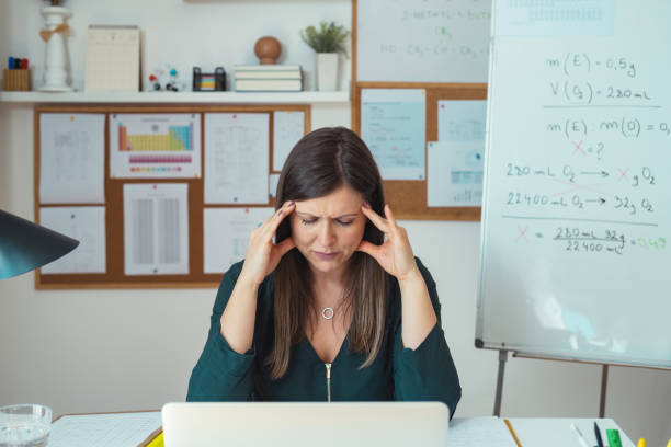 istock Female professor having headache while working at home 1310987276