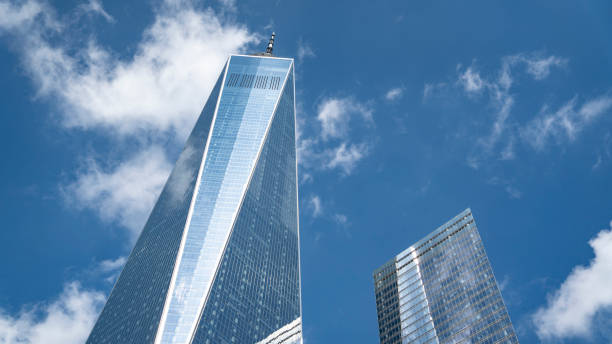 One World Trade Center Blue Sky with clouds behind One World Trade Center in New York City one world trade center photos stock pictures, royalty-free photos & images