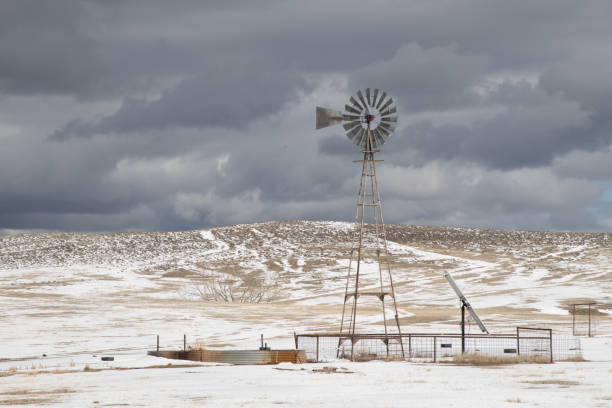 istock Storm threatening windmill with snow covered ground in western USA 1310990678