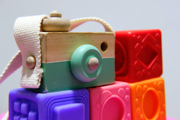 wooden toy camera on top of nesting cubes