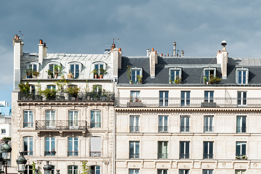 Facade of a Parisian typical freestone building. Paris in France, August 31, 2020