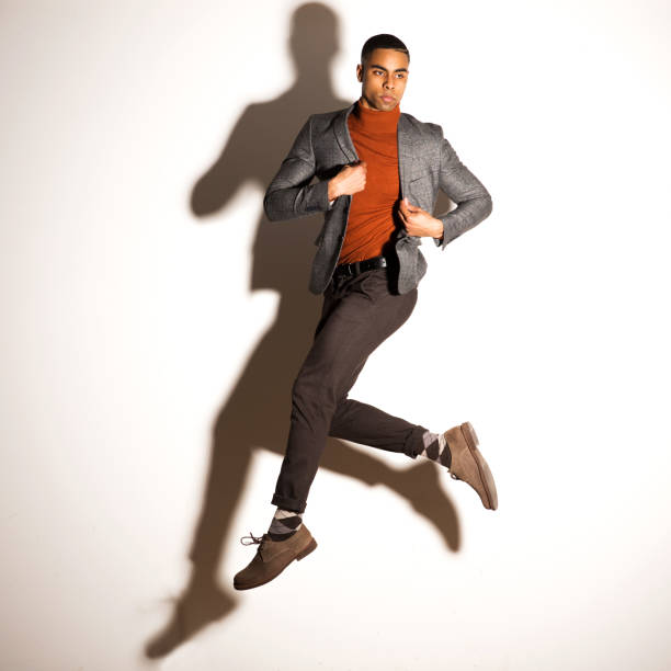 Handsome mixed race male posing in a studio on white background.