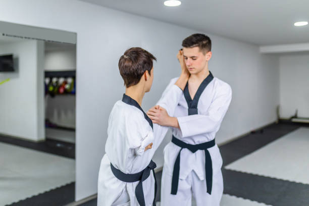 istock Disabled woman training taekwondo with her coach. 1310997584
