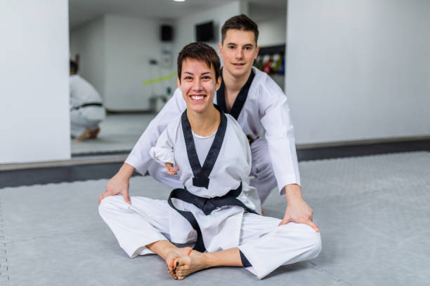 istock Disabled woman training taekwondo with her coach. 1310997596
