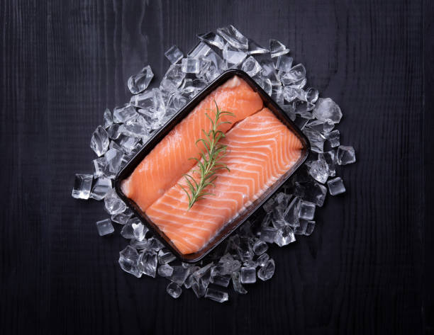 istock fresh salmon in plastic container on wood 1310999269