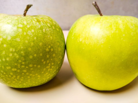 3 April 2021.

Two green apples, but with different skin types. 
With copy space.