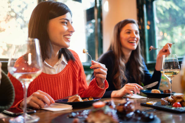 istock Young girlfriends having a lunch in a restaurant 1311001952