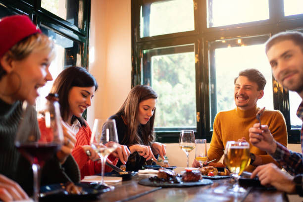 istock Friends enjoying a meal in a restaurant 1311001954