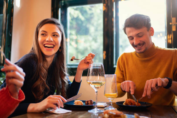 istock Young couple having a lunch in a restaurant 1311001960
