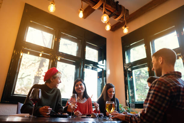 istock Group of young friends dining in a restaurant 1311001972
