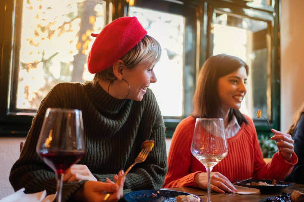 istock Girlfriends having fun during lunch in a restaurant 1311001976