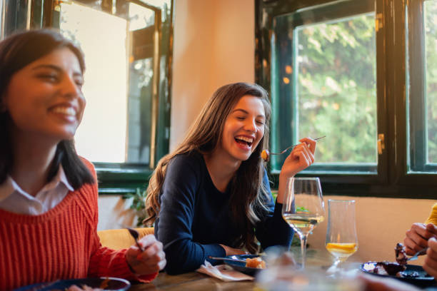 istock Happy girlfriend dining in a restaurant 1311001978