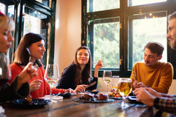istock Happy friends having a lunch in a restaurant 1311002000