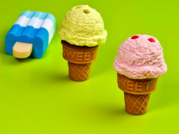 istock Miniature ice cream against lime green background 1311006801