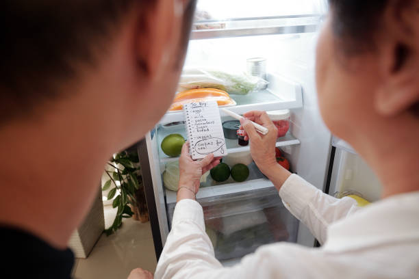 istock Senior woman writing shopping list 1311009680