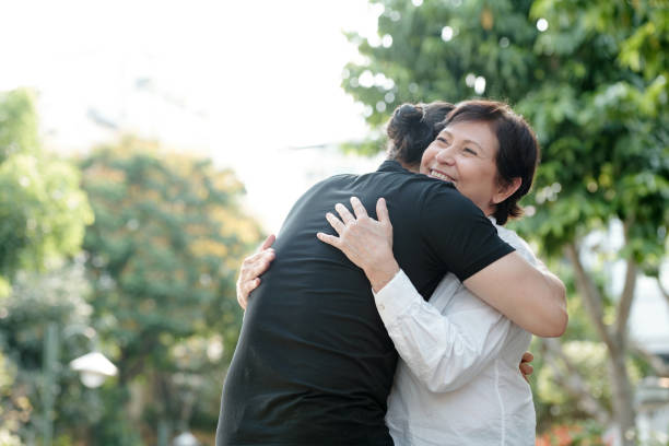 istock Mature woman hugging son 1311009710