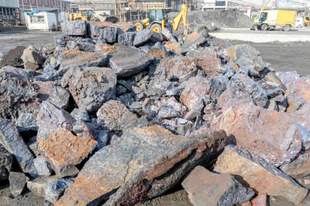 View of the heap of the copper slag in the copper mine factory. Copper slag is a by-product of copper extraction by smelting. During smelting, impurities become slag which floats on the molten metal. View of the heap of the copper slag in the copper mine factory. Copper slag is a by-product of copper extraction by smelting. During smelting, impurities become slag which floats on the molten metal. slag heap stock pictures, royalty-free photos & images